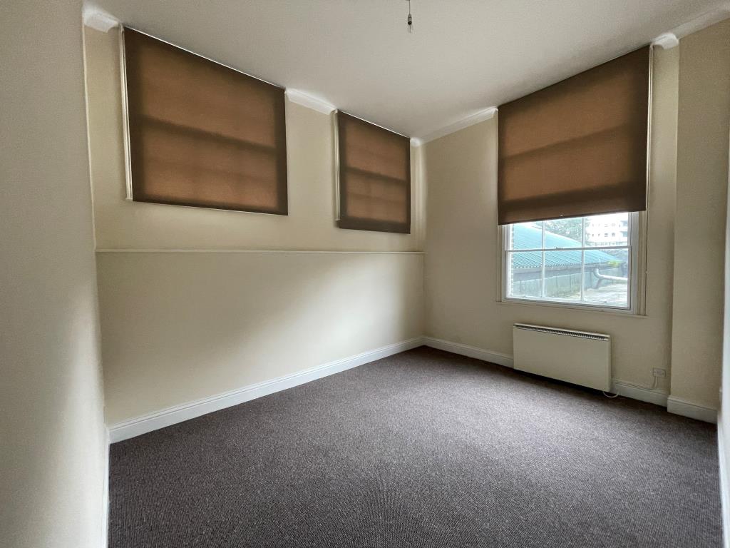 Lot: 24 - VACANT TWO-BEDROOM FLAT - Bedroom with three windows and electric heating